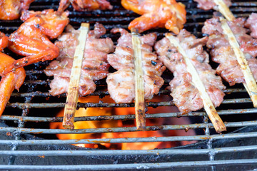  grill pork and chicken wing on bbq flaming grill