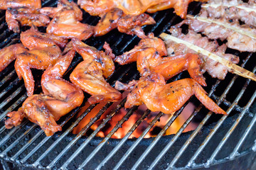  grill pork and chicken wing on bbq flaming grill