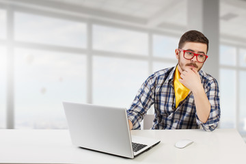 Hipster guy use laptop . Mixed media