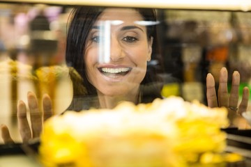 Pretty smiling woman choosing her dessert