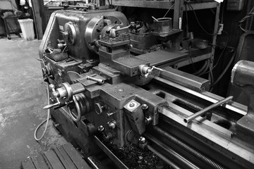 Obsolete lathe. Black-and-white photo.