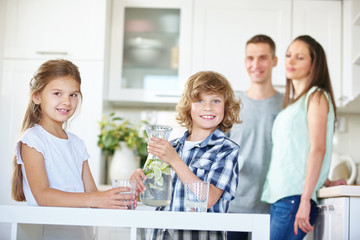 Two kids with carafe full of fresh water