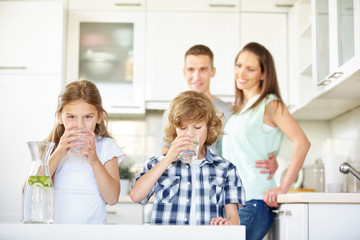Boy and girl drinking water with lime