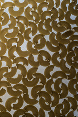 Pasta in the shape of a horn.Abstract food background. 