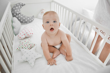 Little baby in crib indoors