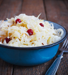 Salad of sauerkraut and carrots in rustic style. Selective focus.