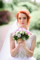 beautiful portrait of young bride with bouquet of flowers