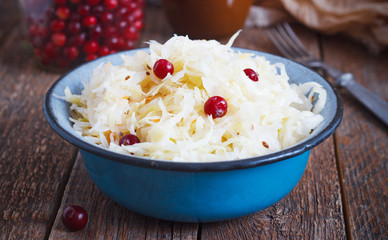 Salad of sauerkraut and carrots in rustic style. Selective focus.