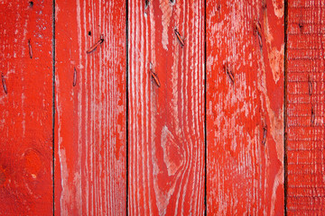 Texture of old wooden fence painted in red