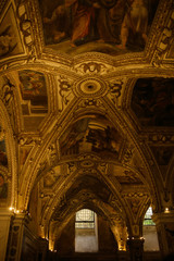 Fototapeta na wymiar Look from below at marvelous ceiling of an old Catholic cathedra