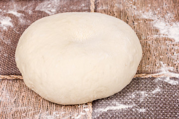 Round pizza dough on the table