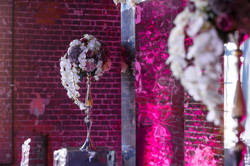 Gorgeous pastel bouquet stands in pink hall with mirrors