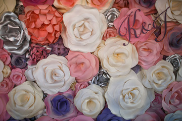 White, pink and silver cloth flowers and initials over them
