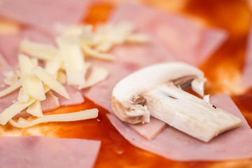 Sliced mushroom on the pizza with ham