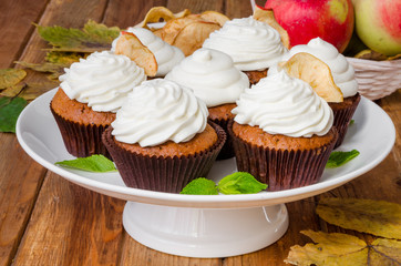 Carrot cupcakes with walnuts and butter cream on top