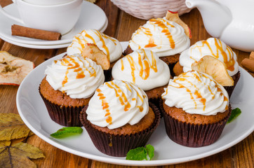 Carrot cupcakes with walnuts and butter cream on top
