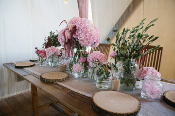 Beautiful dinner table decorated with pieces of dry wood and pin