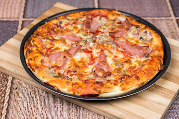 Delicious pizza with ham cheese mushrooms