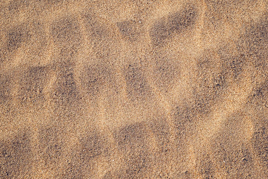 Golden sand texture at the beach.