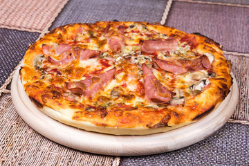 Delicious pizza with ham cheese mushrooms