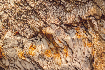 Natural white rock with orange spots.