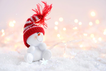 Festive Christmas background with snowman on the snow