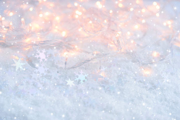 Christmas lights with snowflakes on snow. Christmas festive background