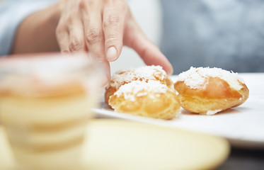 Woman taking eclairs