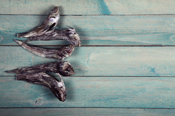 Dry goby fishes on wooden table