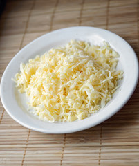 grated cheese on a white plate