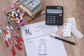 pills, money, syringe, insulin. rx on desk