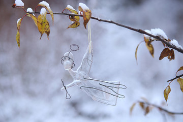 Glass angel in winter background. Fused glass craft work, religion symbol, Christmas decoration.