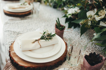 beautiful table setting with wooden disks for wedding guests