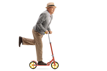 Joyful mature man riding a scooter