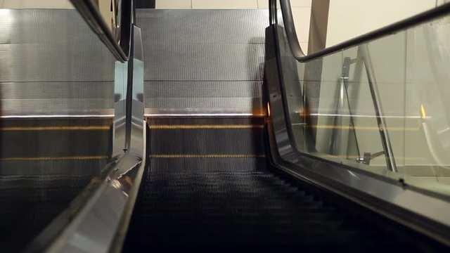 The work of the escalator in the mall, the stairs are moving up
