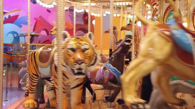 The carousel at the amusement park, different animals
