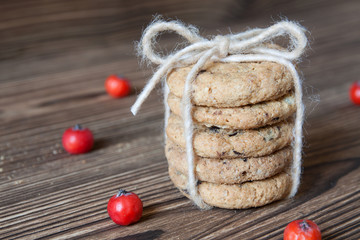 Pile of corded chocolate chip cookies on dark wooden background
