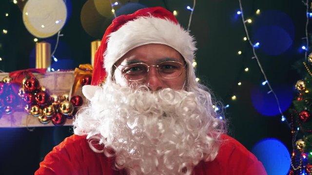 Footage of Santa Claus in eyeglasses looking at camera