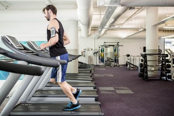 Fototapeta na wymiar Man running on treadmill