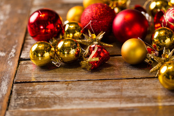 Shiny Christmas balls laying on a rustic table, ready to be hung