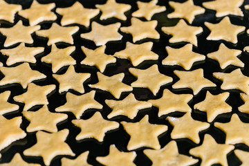 Star shaped cookies pattern on the oven tray ready to bake!
