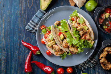 Authentic mexican tacos with chicken and salsa with avocado, tom