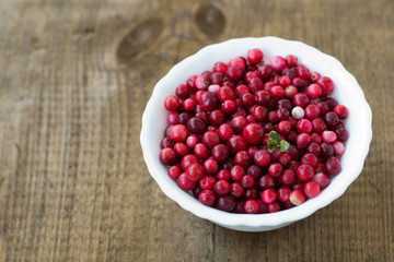 Wild cranberry on wooden texture