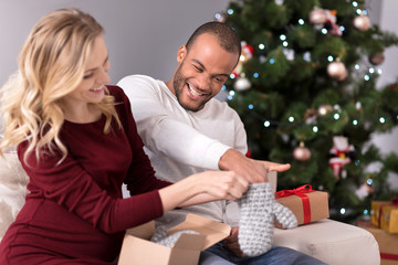 Positive attractive woman holding a mitten