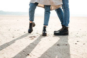 Cropped image of a couple standing together at the seashore