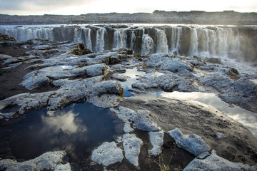 Fototapeta premium Сlouds reflection in a puddle. Sellfoss and Dettifoss waterfall