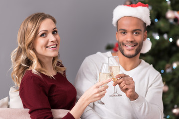 Cheerful good looking couple drinking champagne
