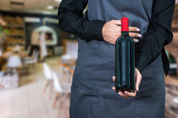 Fototapeta premium woman waitress suggesting bottle of wine