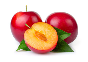 Red plum fruits with green leaves and slice isolated