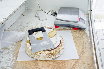 Aging Cheese cut with knife at Franch Comte dairy